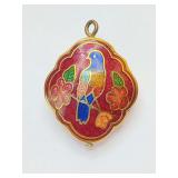 Vintage Chinese cloisonné enamel pendant, doubled sided.
A vibrant blue bird perched on a branch, set against a red background surrounded by red and green floral motifs.
A small, quatrefoil-shaped me