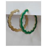 Green and gold colored hoop earrings with a scalloped edge.