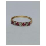 Vintage-style  band ring with 4 Rubies and 3 smaller diamonds set in 10K gold. Size 6. Weighs 0 grams.