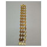 LCI Liz Claiborne vintage-style bracelet is a three-strand gold-tone coin bracelet, featuring circular, textured links that resemble ancient or decorative coins.