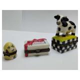 Porcelain hinged trinket boxes, bee hive, candies, milk cow. Milk cow is empty.