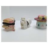 Porcelain hinged trinket boxes, piano, lasso opso, hat on box. Dog and hat are empty.
