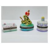Porcelain hinged trinket boxes, sheet birthday cake, prince frog on lilly pad, round cake with candles. Cannot get frog open, round cake is empty.