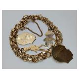 Vintage 12k gold-filled link charm bracelet, by Rhythm. Has 4 charms, 2 figures are 14K, 2 heads unmarked.