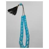 Worry Beads in aqua blue barrel-shaped beads, smooth, polished finish and a subtle, marbled translucent appearance.