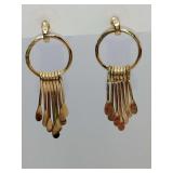 Gold-toned metal dangle earrings featuring a circular hoop design with a graduated fringe of thin, teardrop-shaped metal strands.