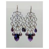 Silver filigree chandelier earrings featuring iridescent purple beads. 2 1/2" long.