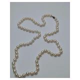 Cultured South Sea pearl necklace, with a sterling 925 clasp. The pearls have ridges and dimples, heavy, cool to touch. Cannot definitely say they are real. 14" long.