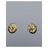 Hammered metal stud earrings featuring a textured, honeycomb-like surface finish.