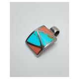 Vintage Native American Navajo or Zuni 925 sterling silver inlay pendant featuring geometric patterns of turquoise and coral. Weighs 2 grams.