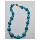 Graduated turquoise beaded necklace, either natural turquoise or turquoise-colored howlite beads interspersed with silver-tone metal spacers and magnetic clasp. Apprx. 8" long.