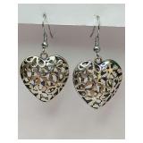 Vintage-style heart-shaped "puffy" dangle earrings with an intricate filigree floral pattern.