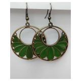 Dangle circular design with green enamel fan-shaped accents in a gold tone finish.