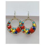 Vibrant gold tone hoop earrings feature a colorful cluster of red, yellow, turquoise, and dark blue stones or beads.