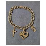 14 karat gold charm bracelet with three 14 karat gold charms. Weight 6.22 grams