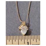14K yellow gold 22 in chain and 14k yellow gold pendant with large clear stone. Weight