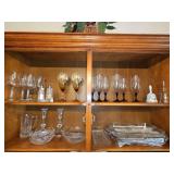 Contents of top two shelves in china cabinet. Crystal candle sticks, crystal pitcher, crystal Bowl, stemware and more. See all photos.