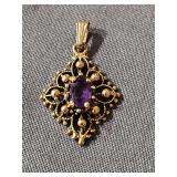 Lovely 14K  gold (marked on bail) pendant with purple centerstone. Weight 1.43 grams