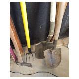 Lawn and garden tools. Short handle shovel, long handle shovel, four tine rake, and axe.