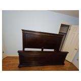 King size bed frame with 60-in tall headboard, 31 in tall footboard, and rails. Did not find a manufacturer's mark.