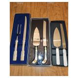 Three sets of serving utensils. Mother of Pearl-look Sheffield pie and cake, colorful porcelain handle butterflies pie and cake servers, Towle carving set knife and fork.