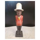 Vintage West African hand-carved wooden "colon" statue featuring a figure in a red jacket and white helmet