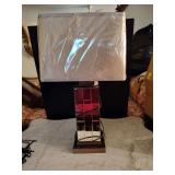 Table lamp with a rectangular mirrored base and a fabric shade still in its protective plastic packaging. Untested