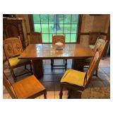 Antique oak table over 100 years old with eight chairs, which includes one arm chair. Has two 12” leaves that attached to the ends of the table. All chairs in great condition with the exception of o