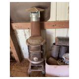 Sun Oak number 13 potbelly stove in barn. 16” x 16” x 55” as is.