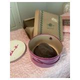 Two vintage hat boxes with one hat