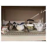 Grouping of various teapots and pitchers with a brass bell.. see photos for condition
