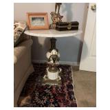 Antique Marble top Brass and metal side table with cherub. 24 1/2 inch round by 26 3/4” tall. Contents on top not included.