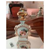 Two Amogee hand painted porcelain perfume bottles blue with roses 4” x 6 1/4. Does have some chipping as shown. With an Amogee matching trinket dresser box.