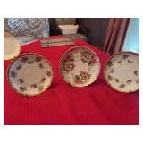 Set of three porcelain saucers
