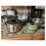 Miscellaneous vintage pots, pans, and mixing bowls as shown