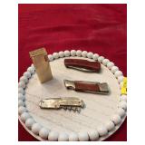 Windsor Canadian gold butane lighter, with three knives one is a duck unlimited, and one is pearl handled advertisement