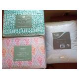 1 New queen sheet set white/green. 1 New queen sheet set pink/gray. And, 1 new queen mattress pad,