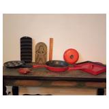 Collection of vintage and enameled cast iron cookware pieces, a brass gingerbread man mold.