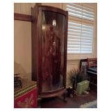 Antique curved glass curio or china cabinet,  constructed from quarter-sawn tiger oak. There are no shelves. The left side has markings, possibly built in see pics. 63" T x 22" W x 15.75" D. Other ite