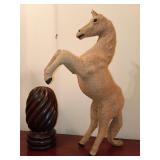 Rustic, handcrafted rearing horse sculpture covered in natural burlap fabric with dark-accented hooves, capturing a classic folk-art style, 23"T and a hand-carved wooden finial in a spiral gadroon pat