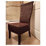 Pier 1 Brown Wicker Dining Chair features a woven dark brown rattan finish with sleek dark wood legs and a high-backed silhouette. Back height 62.5", seat height 18.25", 19"W, 24"D.