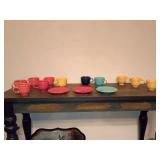 Fiestaware tea cup and saucers, mix of retired and contemporary glazes, 3 yellow cups on right have no markings ? and 1 is chipped.