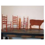 3 miniature/doll ladderback chairs natural/cherry finish and a flat, detailed wooden cutout silhouette of a dairy cow.