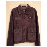XL Cuero dark brown suede leather button-front jacket with a classic spread collar and textured front buttons. Structured utility flap pockets. Pocket on sleeve left forearm, pocket right side at hip 