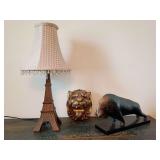 Eiffel Tower novelty table lamp 20"T, gold-painted lion head wall hanging 7" x 6", modernist stylized sculpture bull or buffalo 13"L x 7.25"T. All pieces are resin.