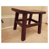 Small saddle seat wooden stool/foot/step stool in dark finish, 11.25" T x 13.75"L x 8.25"D. Does have some wear on edges.