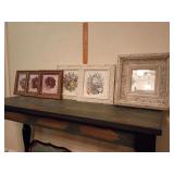 Ornately framed small floral prints and mirror