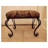 Wrought iron bench/stool, scrollwork frame and an elongated rectangular cushion upholstered in a classic multi-colored paisley patterned fabric. 14.75"T x 18.5"L x 14 5"D.