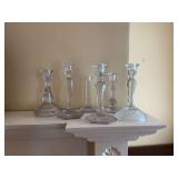 Group of six crystal and glass candle holders. Various heights from 6 1/4 inches to 8 1/2 inches.