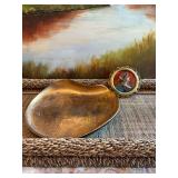 Sascha Brastoff kidney shaped tray. Black and gold 10 1/2 inches.Some water stains. Also an enamel female portrait medallion framed. Frame is broken. 4 1/2 inches.